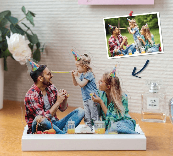 An acrylic photo cutout of a family, standing on a shelf