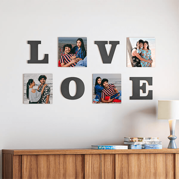A photo gallery set arranged on a living-room wall